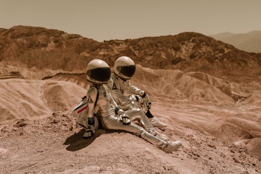 pexels-photo-8474489-8474489 Two astronauts in silver suits sitting on a barren desert landscape, exploring new realms.